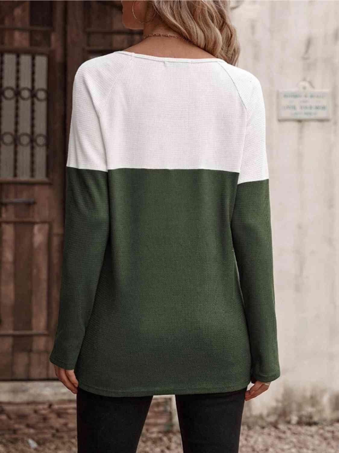 a woman wearing a green and white sweater