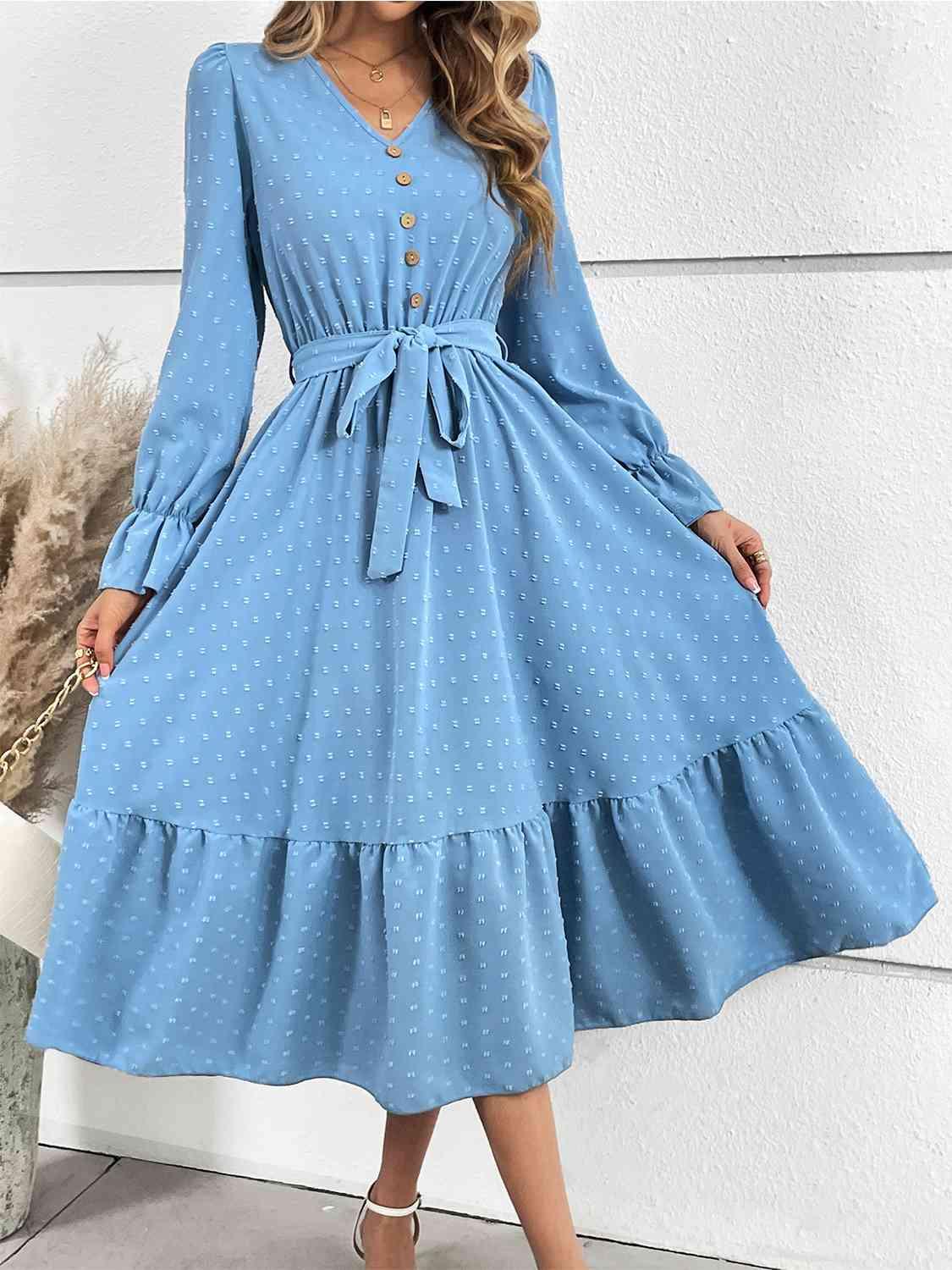 a woman wearing a blue polka dot dress