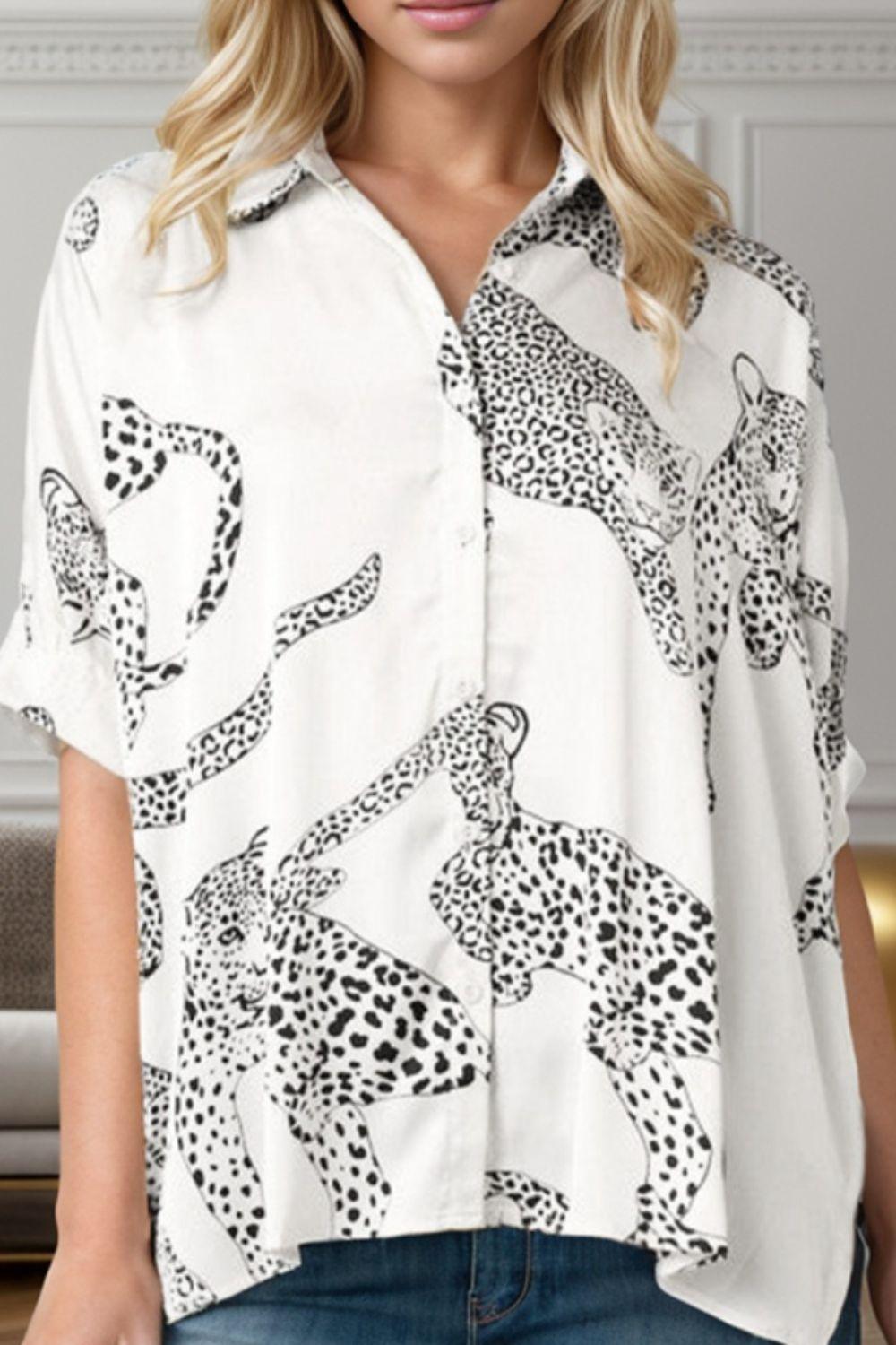 a woman wearing a white shirt with black and white leopards on it