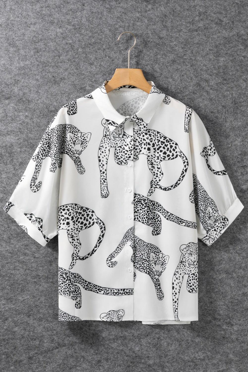a white shirt with black and white leopards on it