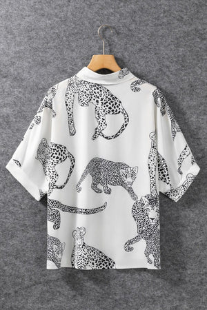 a white shirt with black and white leopards on it