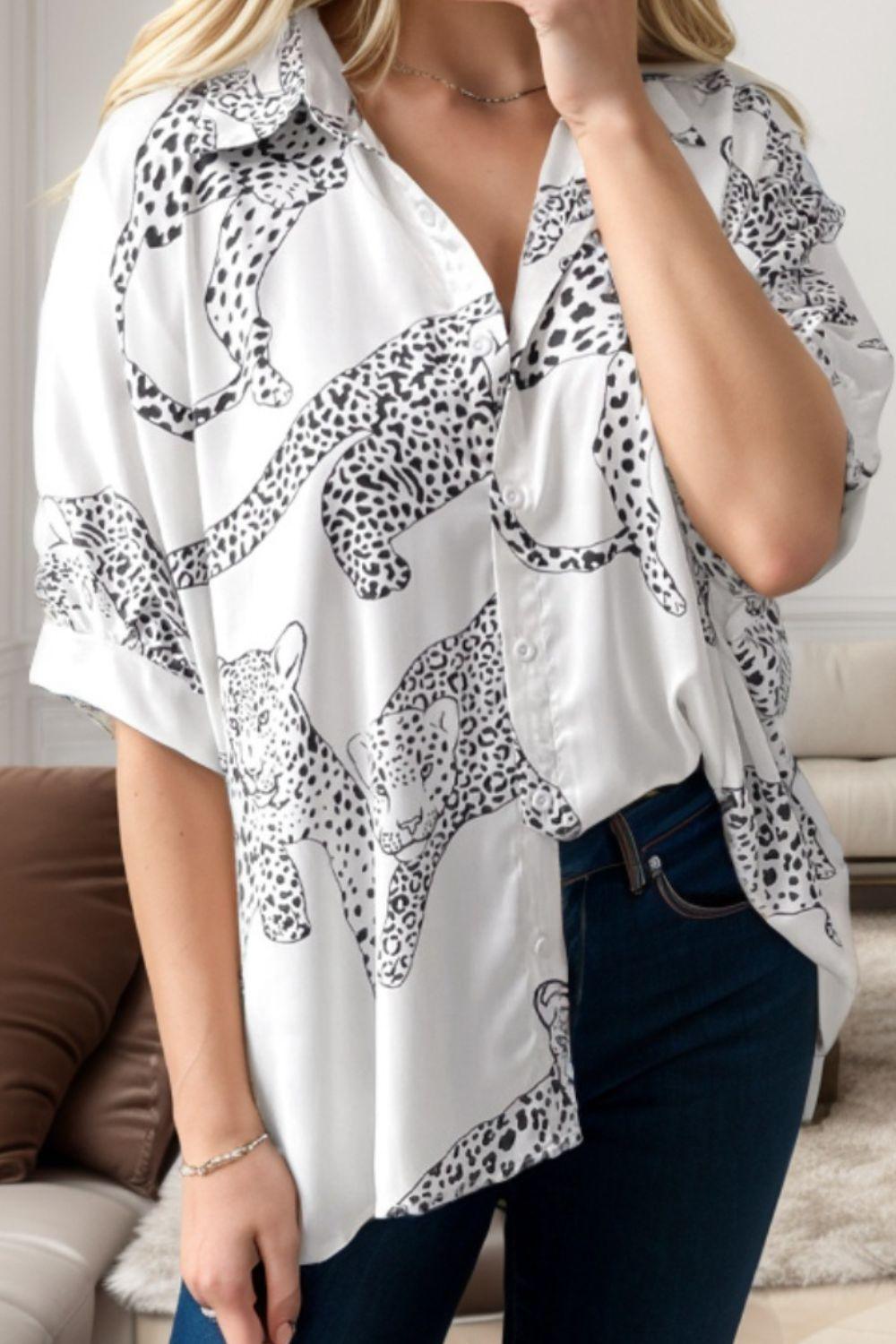 a woman wearing a white shirt with a leopard print on it