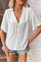 a woman wearing a white shirt and denim shorts