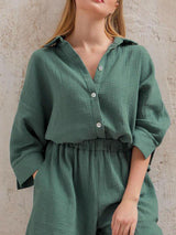 a woman wearing a green shirt and pants