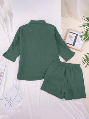 a green shirt and shorts on a bed