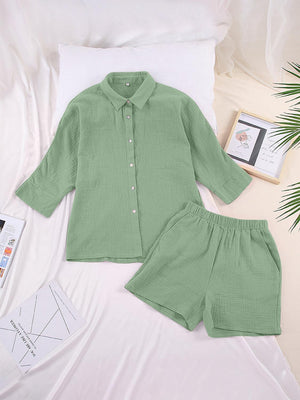 a green shirt and shorts on a bed