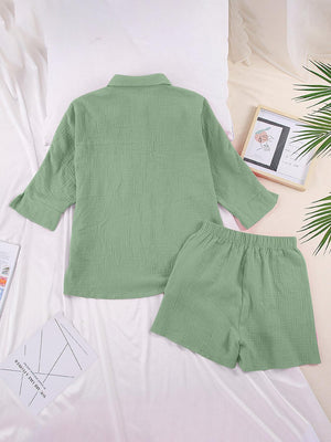 a green shirt and shorts on a bed