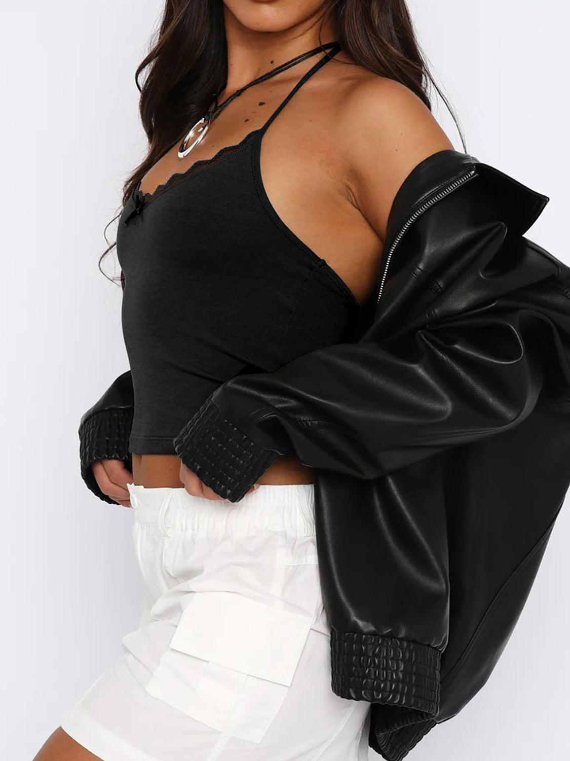 a woman wearing a black crop top and white shorts