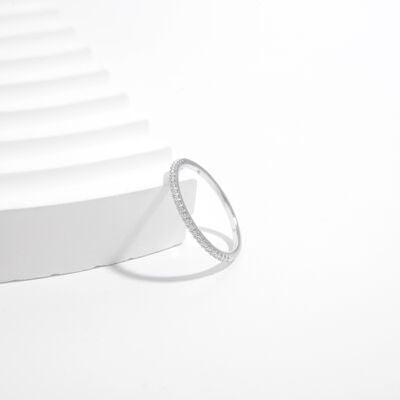 a diamond ring sitting on top of a white surface