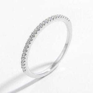 a close up of a diamond ring on a white background