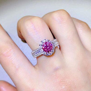 a woman's hand with a pink and white diamond ring