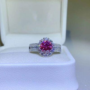 a pink and white diamond ring in a box