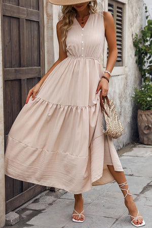 a woman in a dress and hat walking down the street