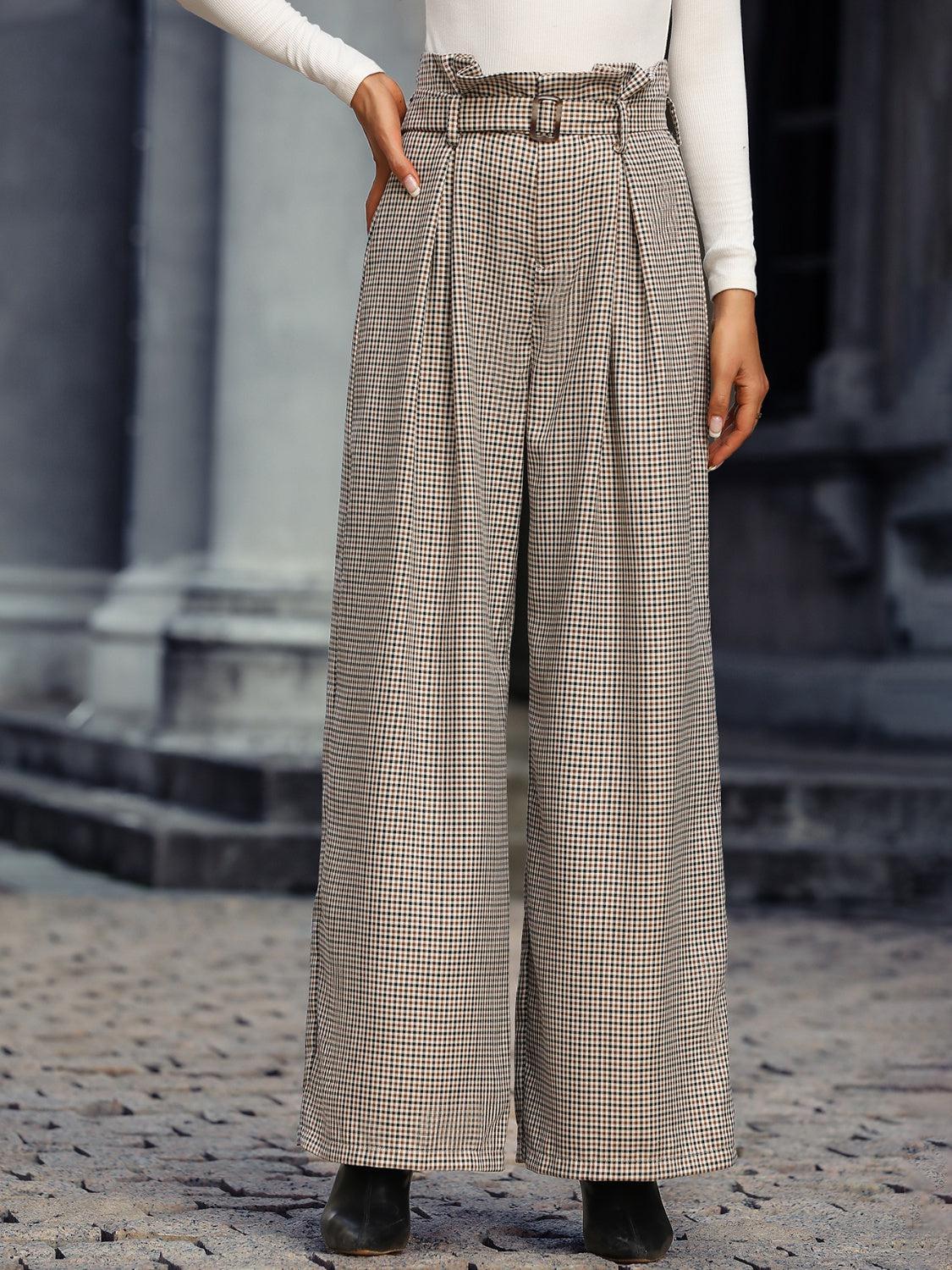 a woman in a white shirt and checkered pants