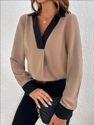 a woman in black pants and a beige blouse