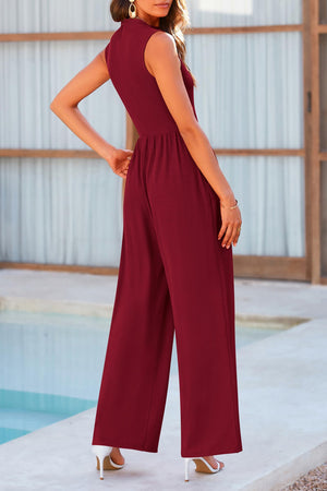 a woman standing next to a pool wearing a red jumpsuit