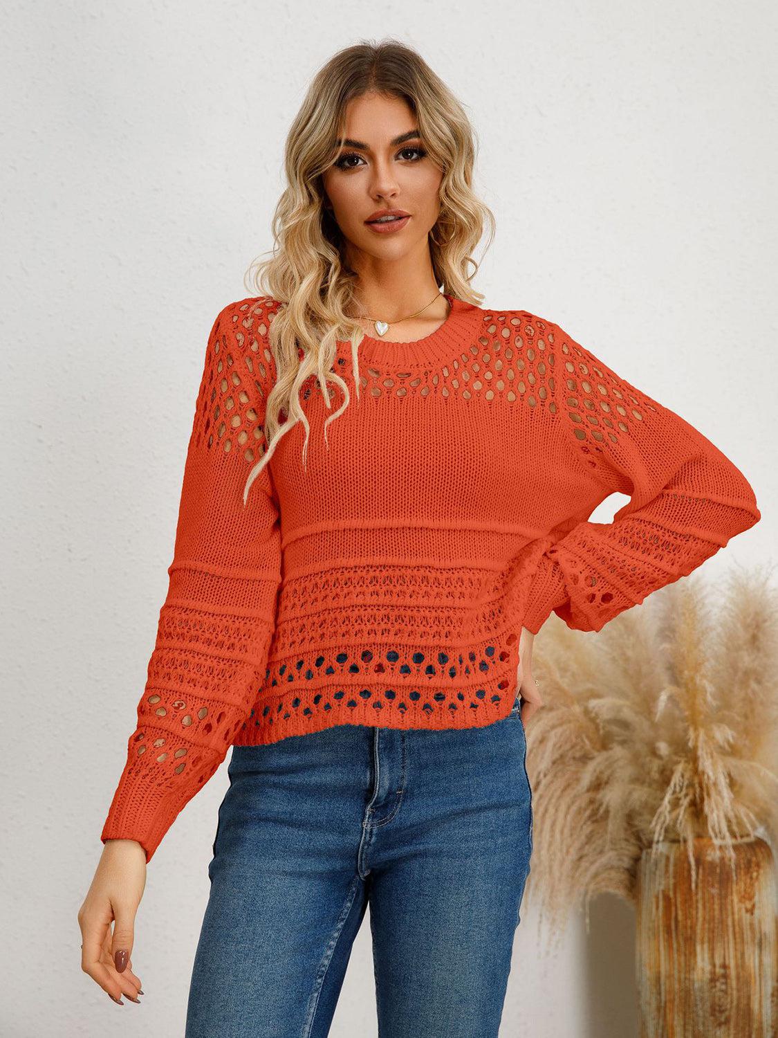 a woman wearing an orange sweater and jeans