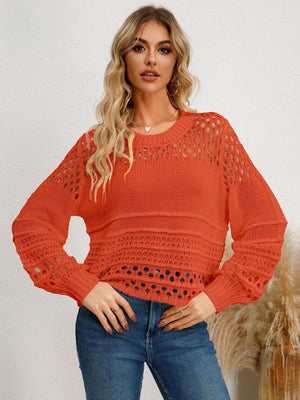 a woman wearing an orange sweater and jeans