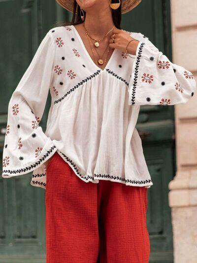 a woman wearing a hat and red pants