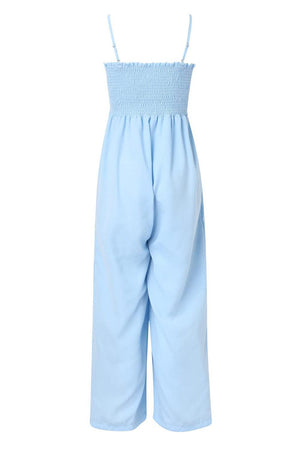 a blue jumpsuit with straps and a white top