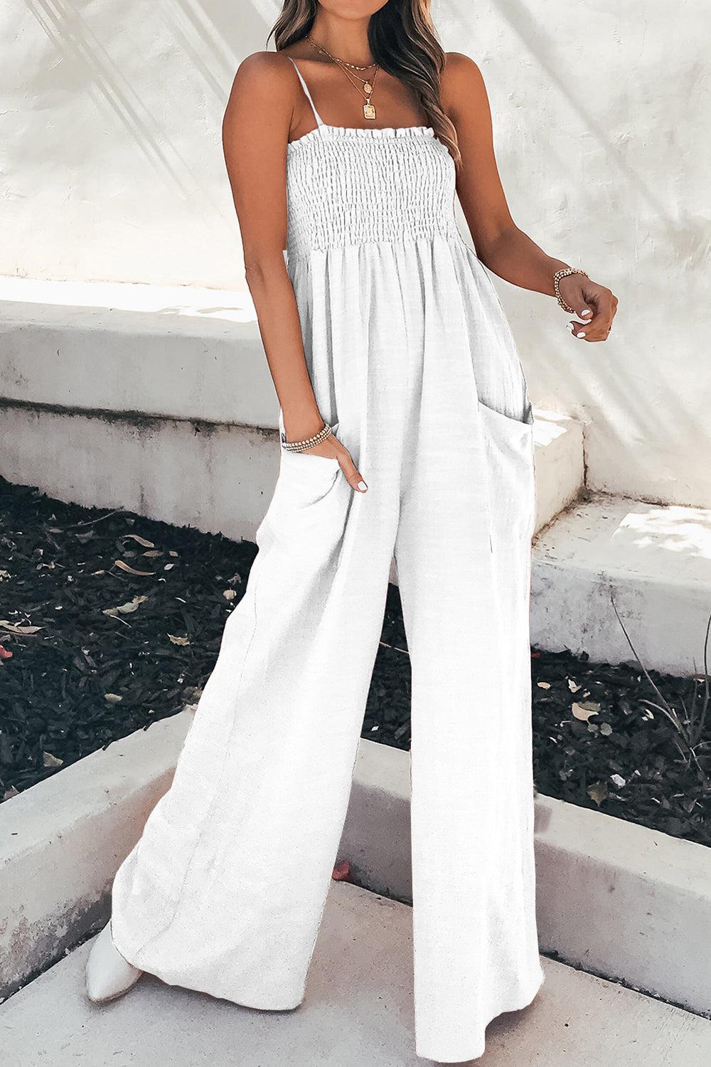 a woman wearing a white jumpsuit and a straw hat