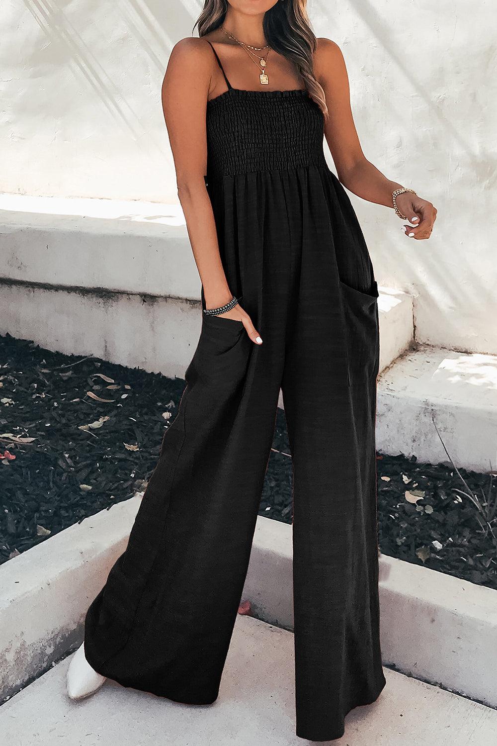 a woman in a black jumpsuit posing for a picture