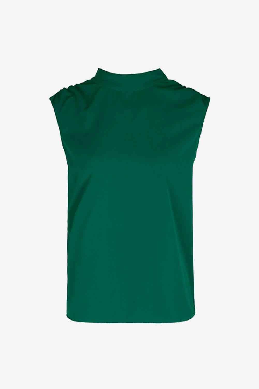 a green top with ruffles on the shoulders