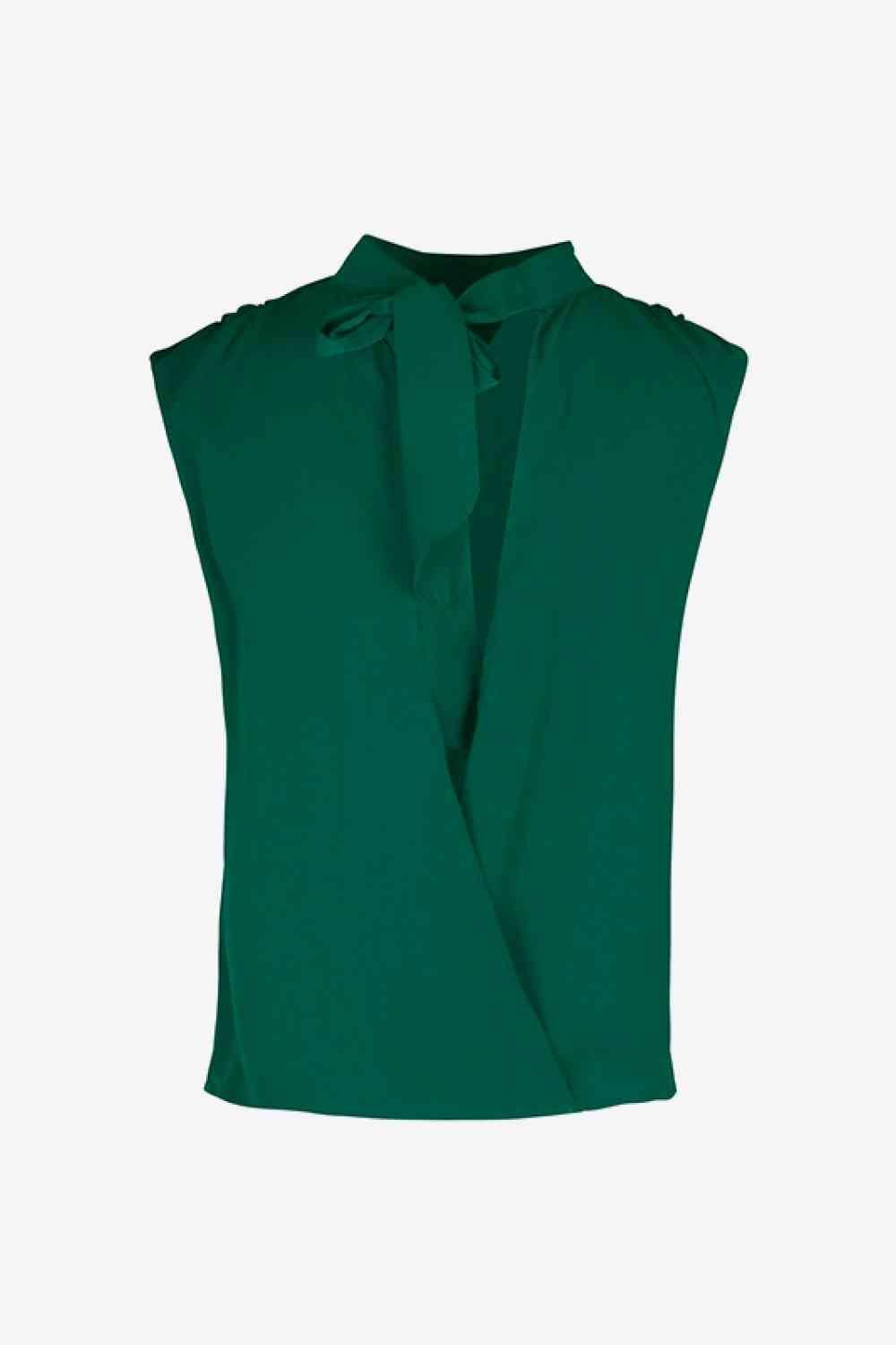 a green blouse with a bow at the neck