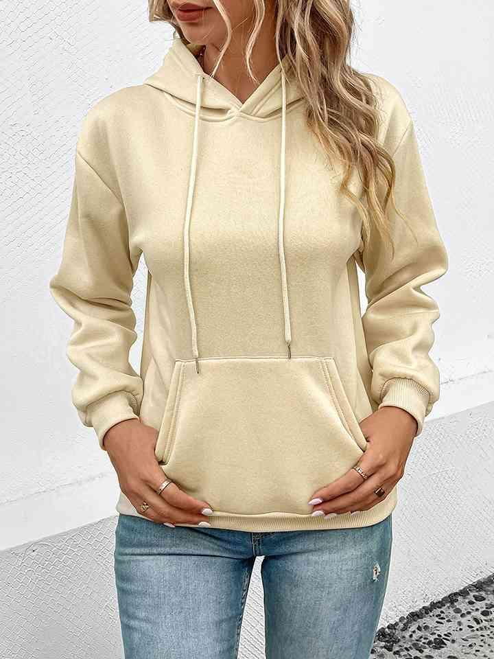 a woman wearing a white hoodie and jeans
