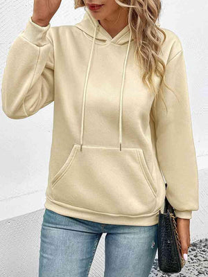 a woman wearing a white hoodie and jeans