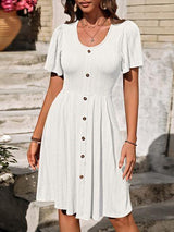 a woman wearing a white dress and sandals