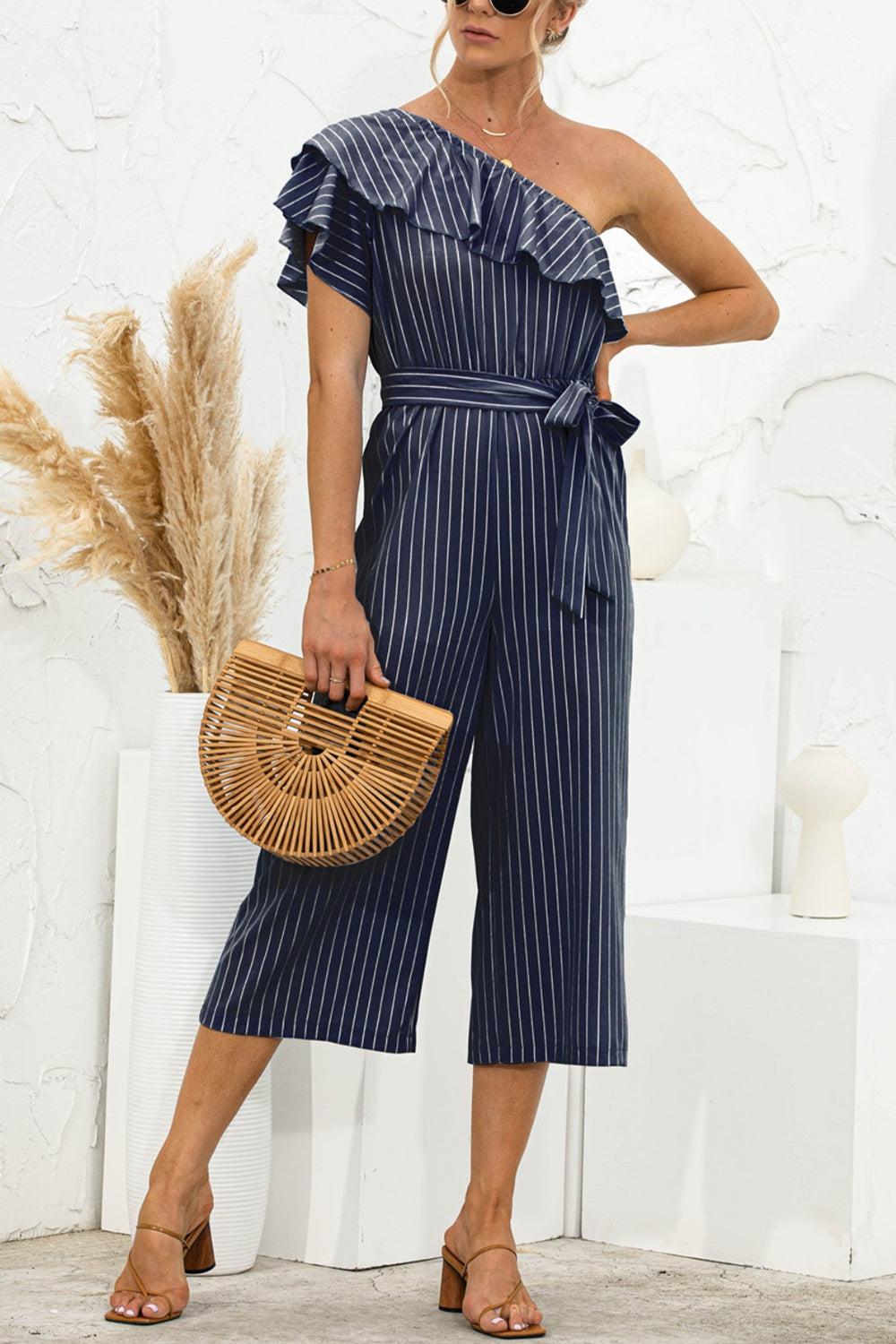 a woman in a blue striped jumpsuit holding a basket