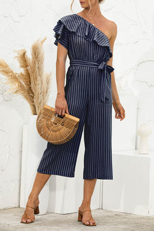 a woman in a blue striped jumpsuit holding a basket