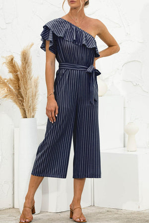 a woman wearing a blue striped jumpsuit