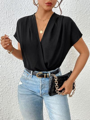 a woman wearing a black shirt and jeans