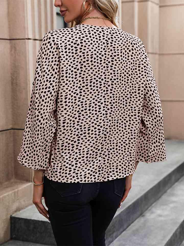 a woman wearing a leopard print jacket and jeans