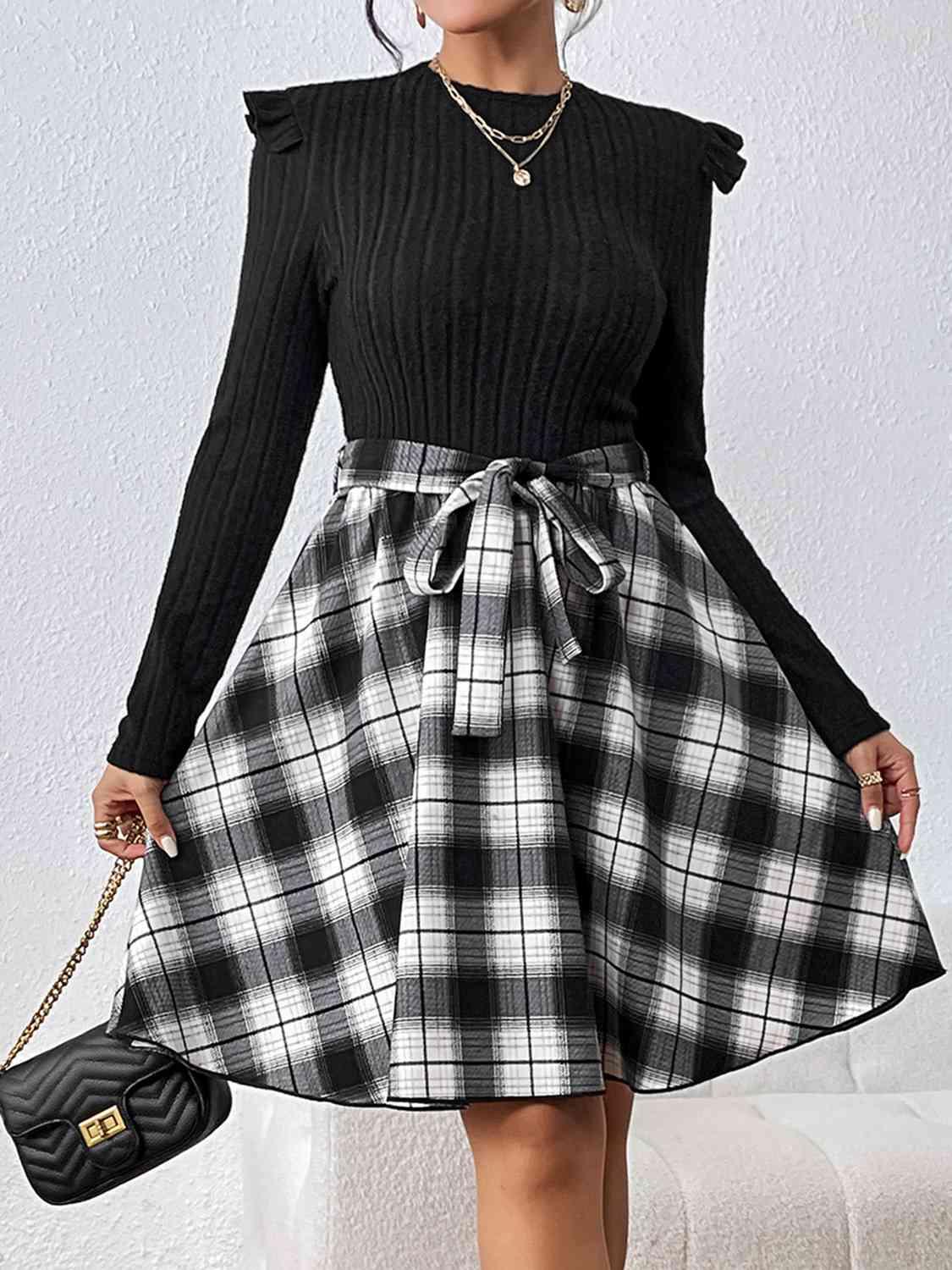 a woman wearing a black and white plaid skirt