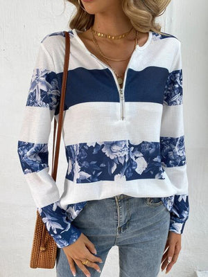 a woman wearing a white and blue striped top