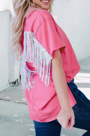 a woman wearing a pink shirt with fringes on it