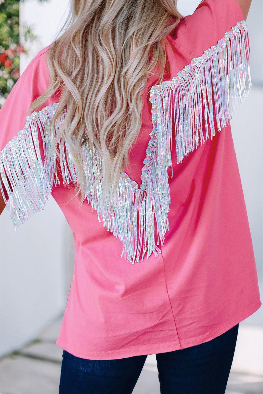 a woman wearing a pink top with white fringes