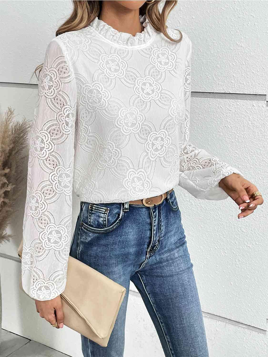 a woman wearing a white blouse and jeans