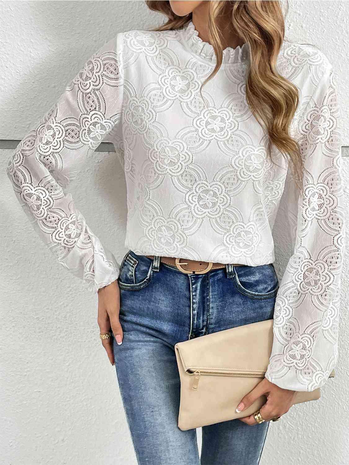 a woman wearing a white blouse and jeans