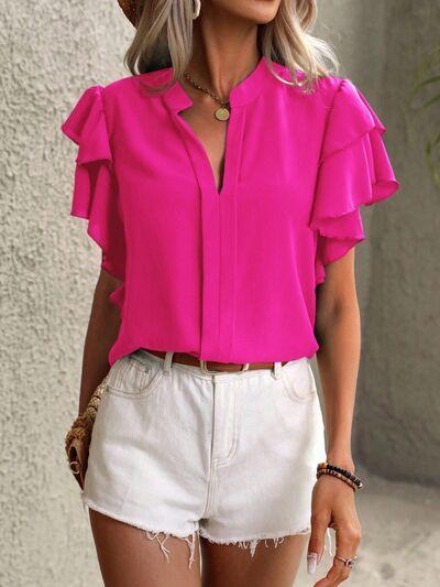 a woman wearing a pink top and white shorts