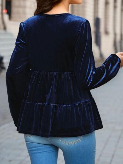 a woman in a blue top is walking down the street