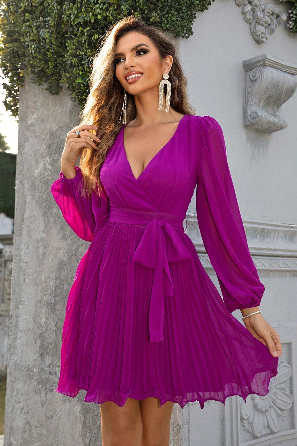 a woman in a purple dress posing for a picture