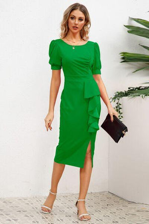 a woman wearing a green dress and heels