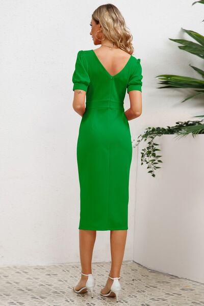 a woman in a green dress looking back