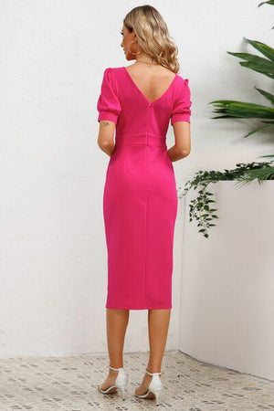 a woman in a pink dress looking back