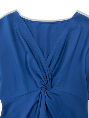 a blue top with a knot on the front