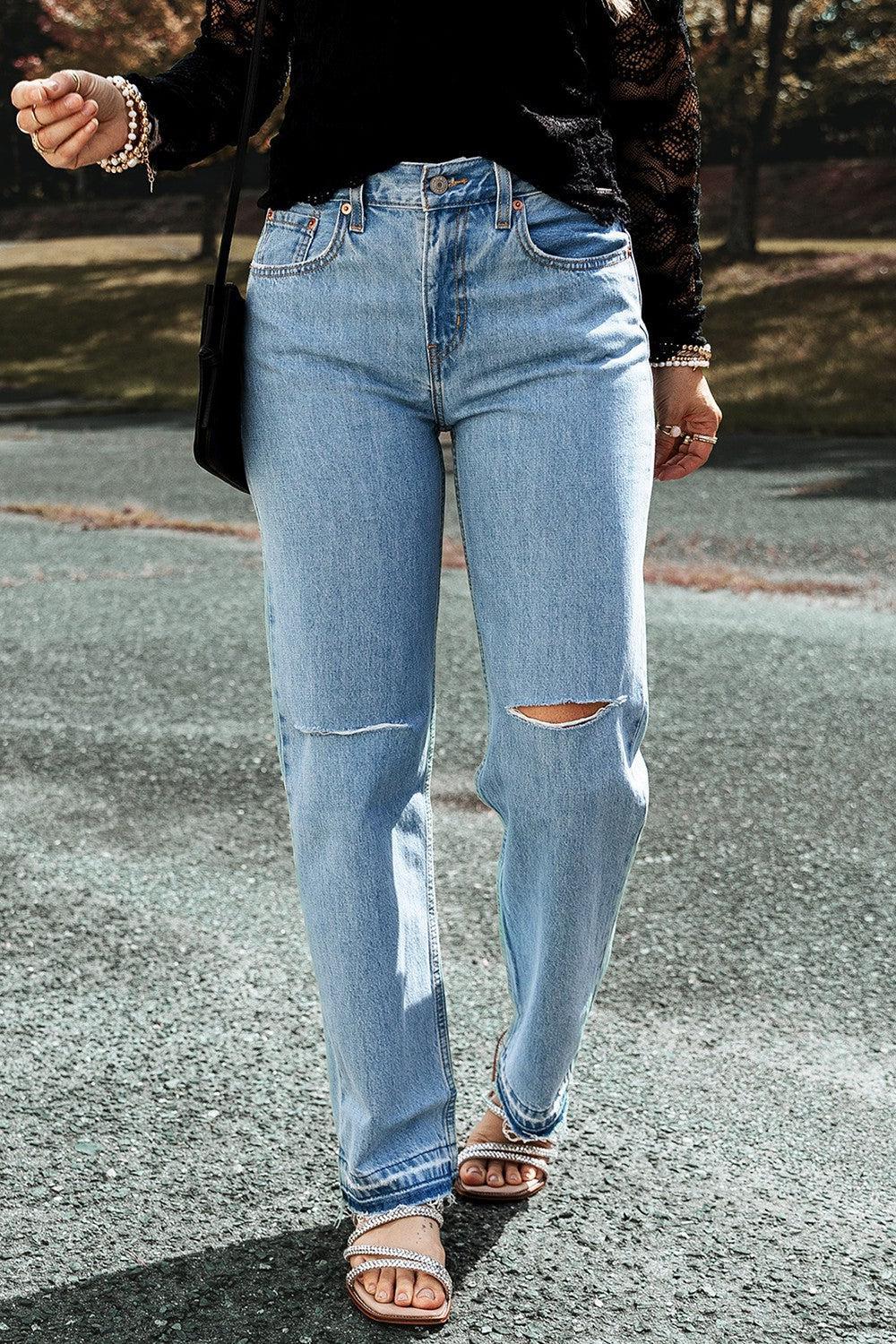 a woman in black shirt and jeans walking on street